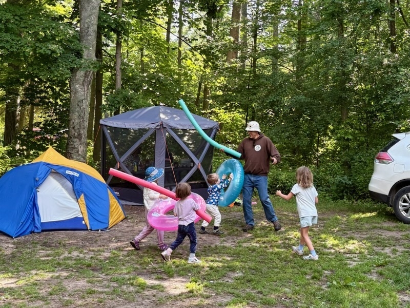 Parker playing with four kids while camping.