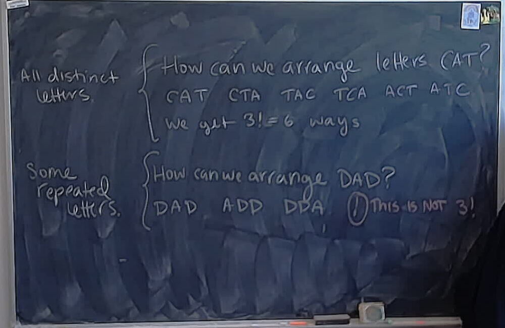 A photo of a whiteboard titled: Arranging letters of CAT and DAD