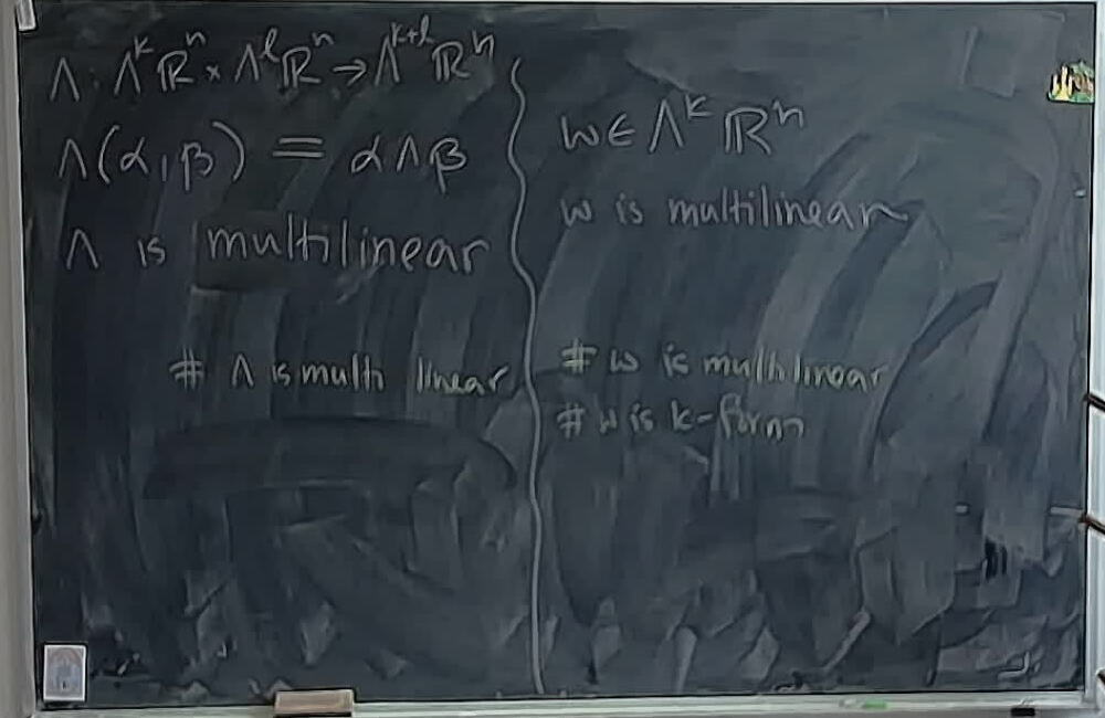A photo of a whiteboard titled: Multilinearity of Wedge versus Forms